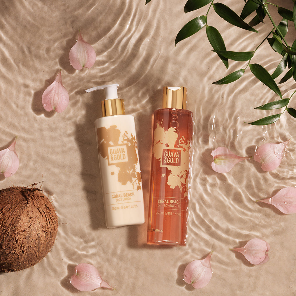 Guava & Gold body lotion and shower gel reflected in water