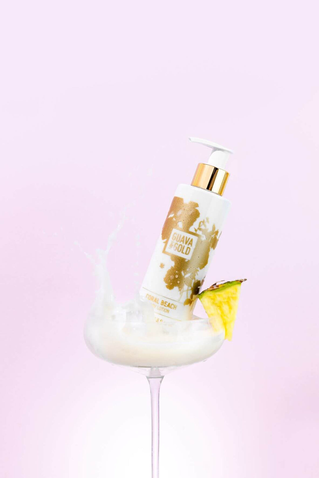 Guava & Gold Coral Beach Body Lotion in cocktail glass